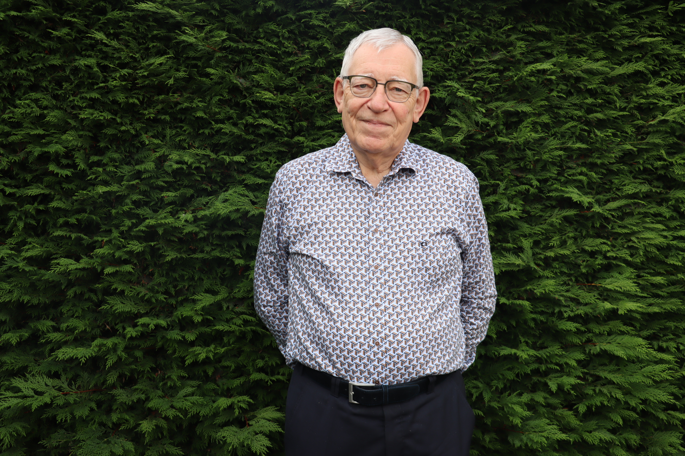 Stephan Vermeulen voor een groene struik